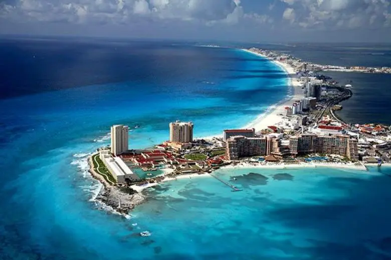 Mexico cruise deal showcasing a ship sailing toward vibrant coastal towns, golden beaches, and turquoise waters along the Pacific and Caribbean shores