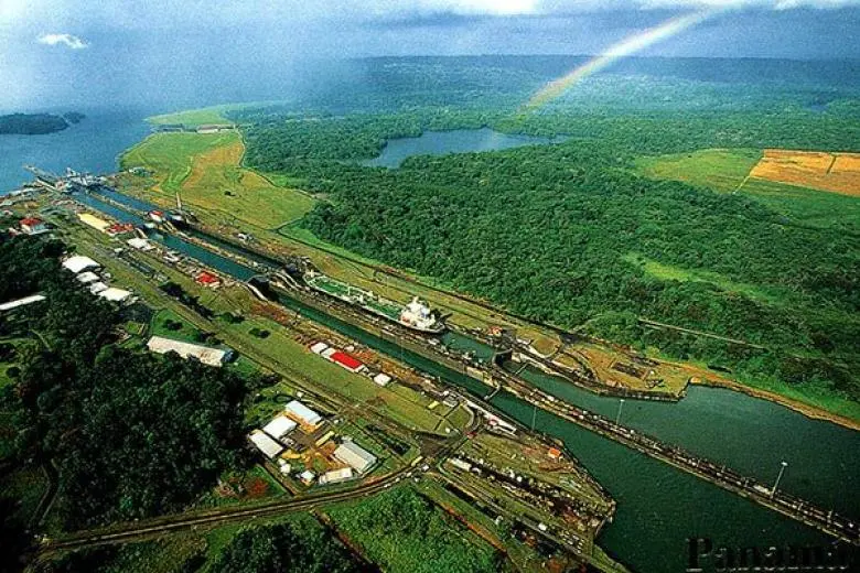 Panama cruise deal featuring a ship approaching the Panama Canal with views of tropical rainforests, engineering marvels, and lush coastal landscapes