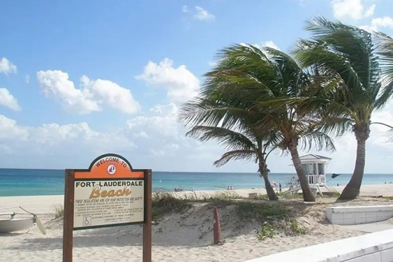 Fort Lauderdale cruise deal featuring a ship sailing toward Florida’s sunny coastline with views of palm-lined beaches, city skylines, and the Port Everglades cruise hub