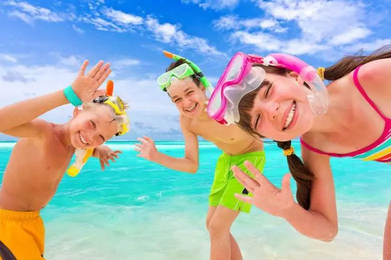Family cruise deal showcasing a fun-filled ship with water slides, kids’ clubs, and family-friendly entertainment sailing across sunny ocean waters